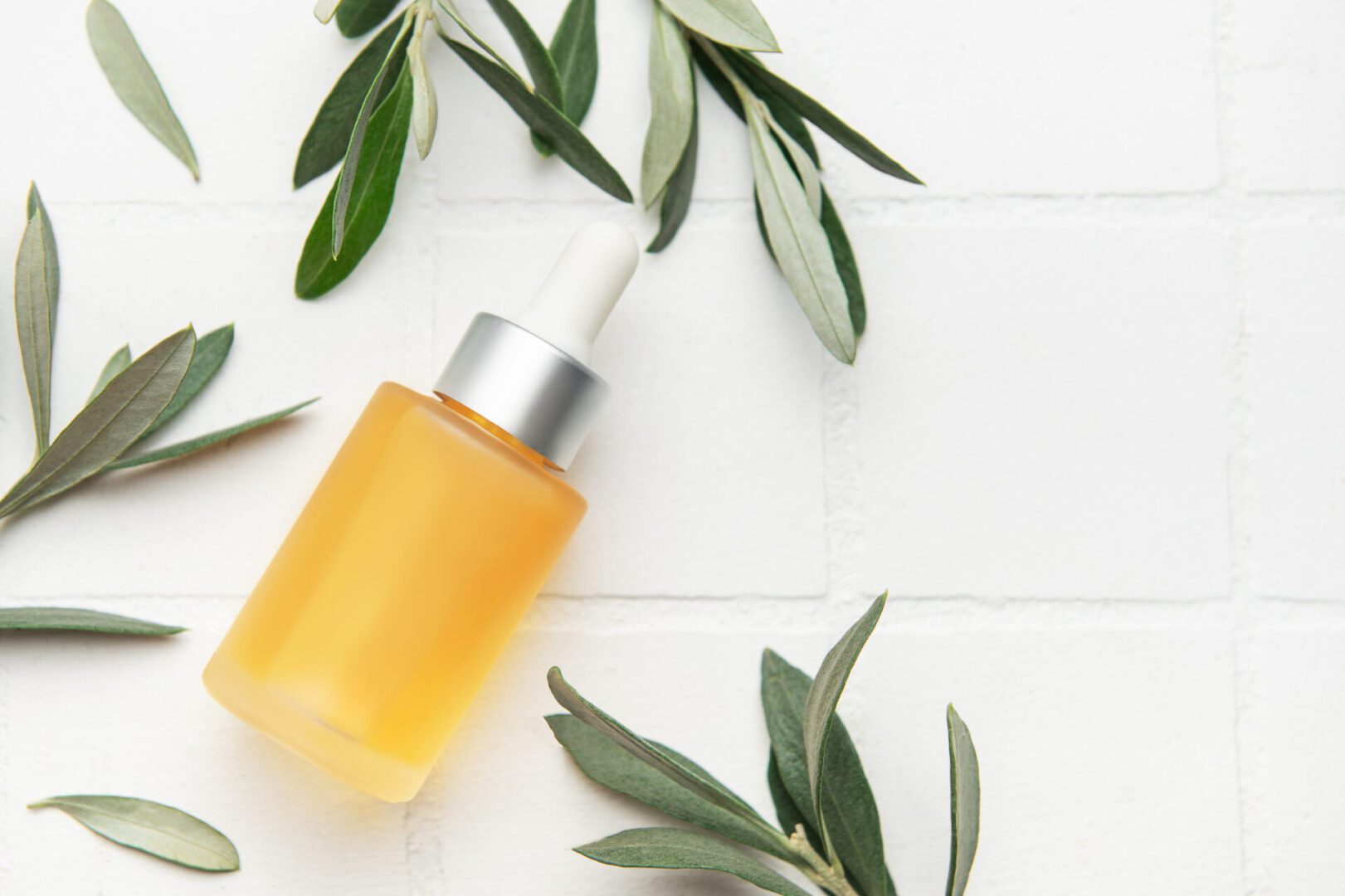 Amber dropper bottle with green leaves