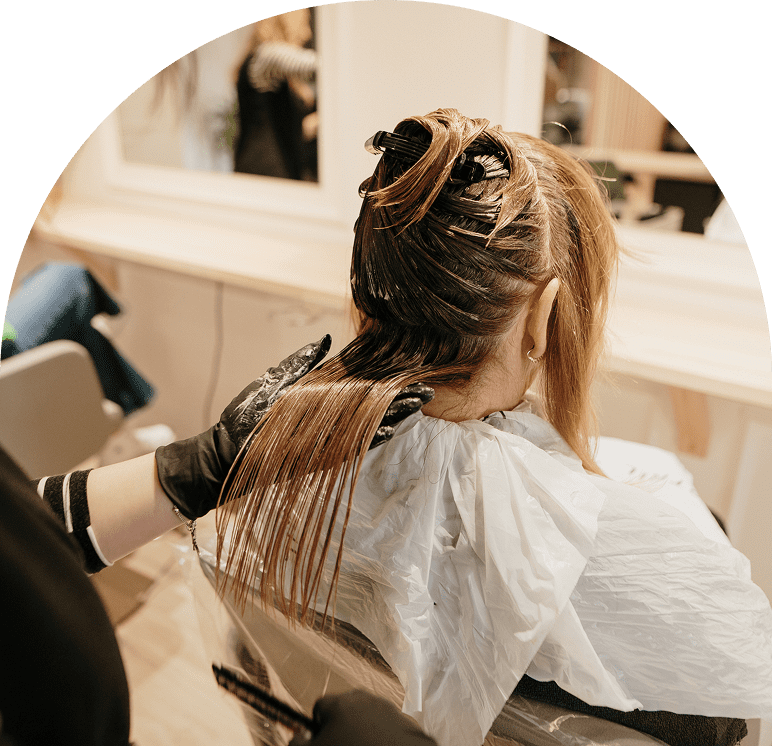 Woman's hair being dyed in salon